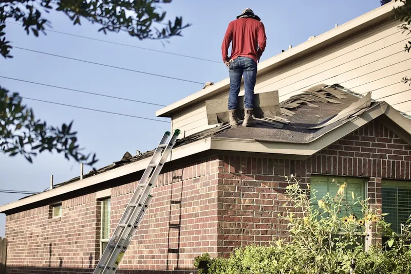 Professional roofer working on a residential roof in Roselle